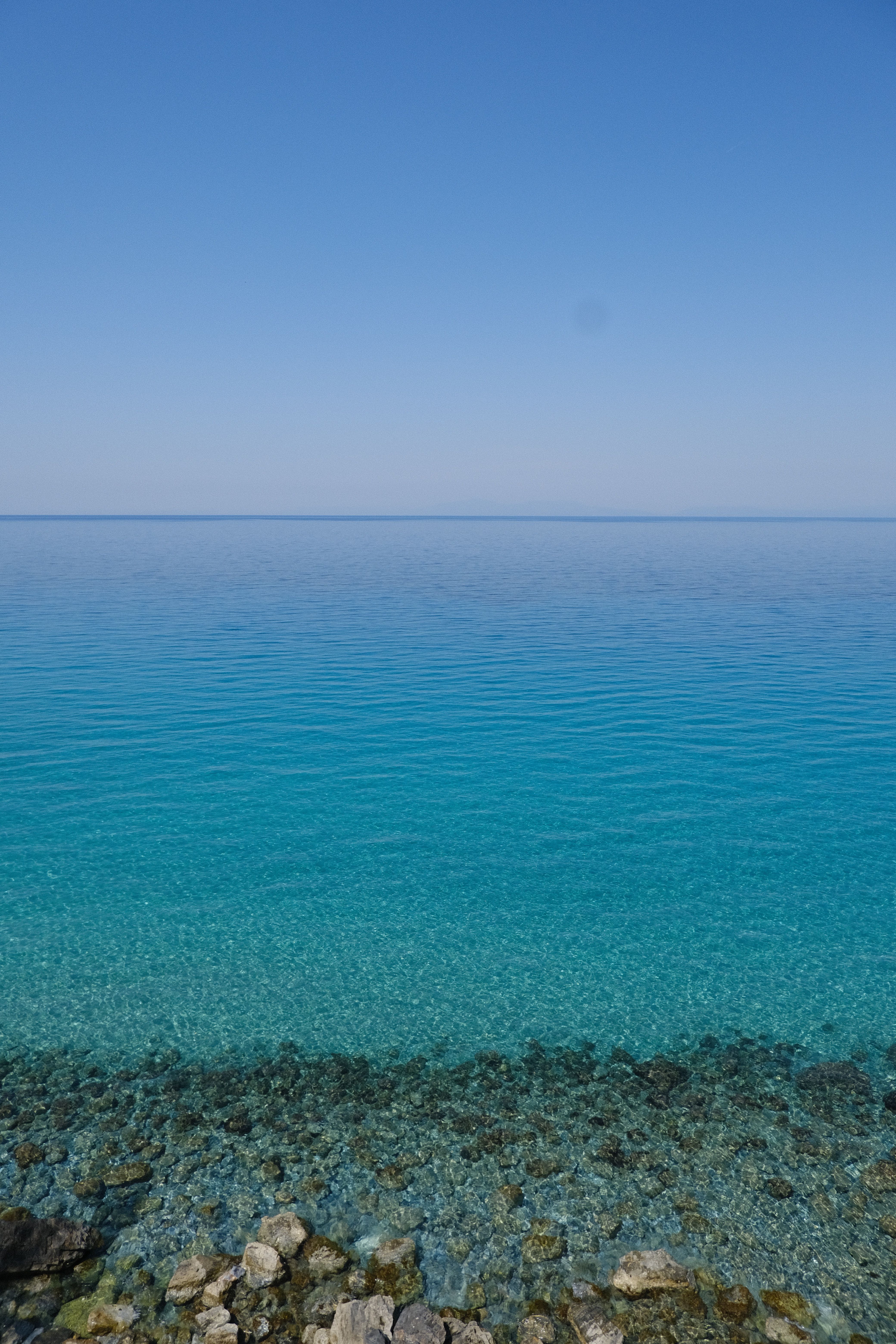 Crystal-clear water over pebbles