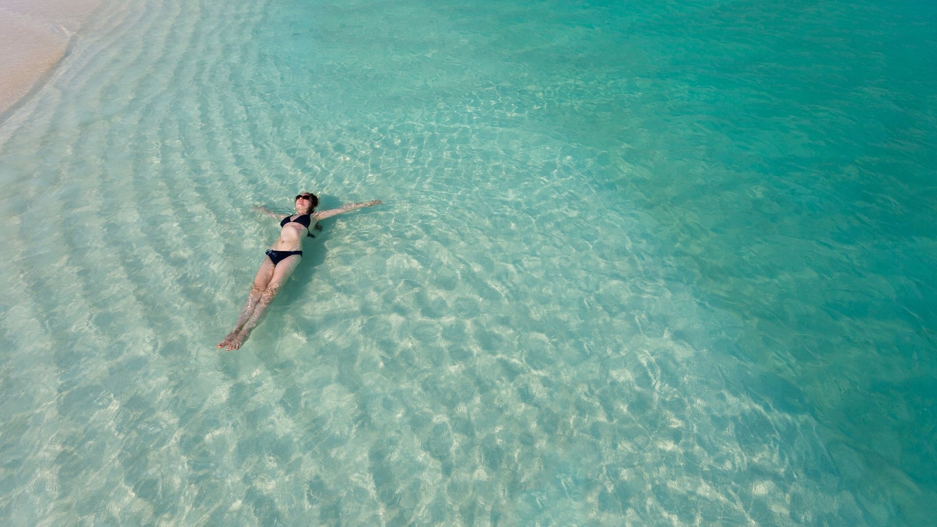 Floating weightless in clear turquoise water
