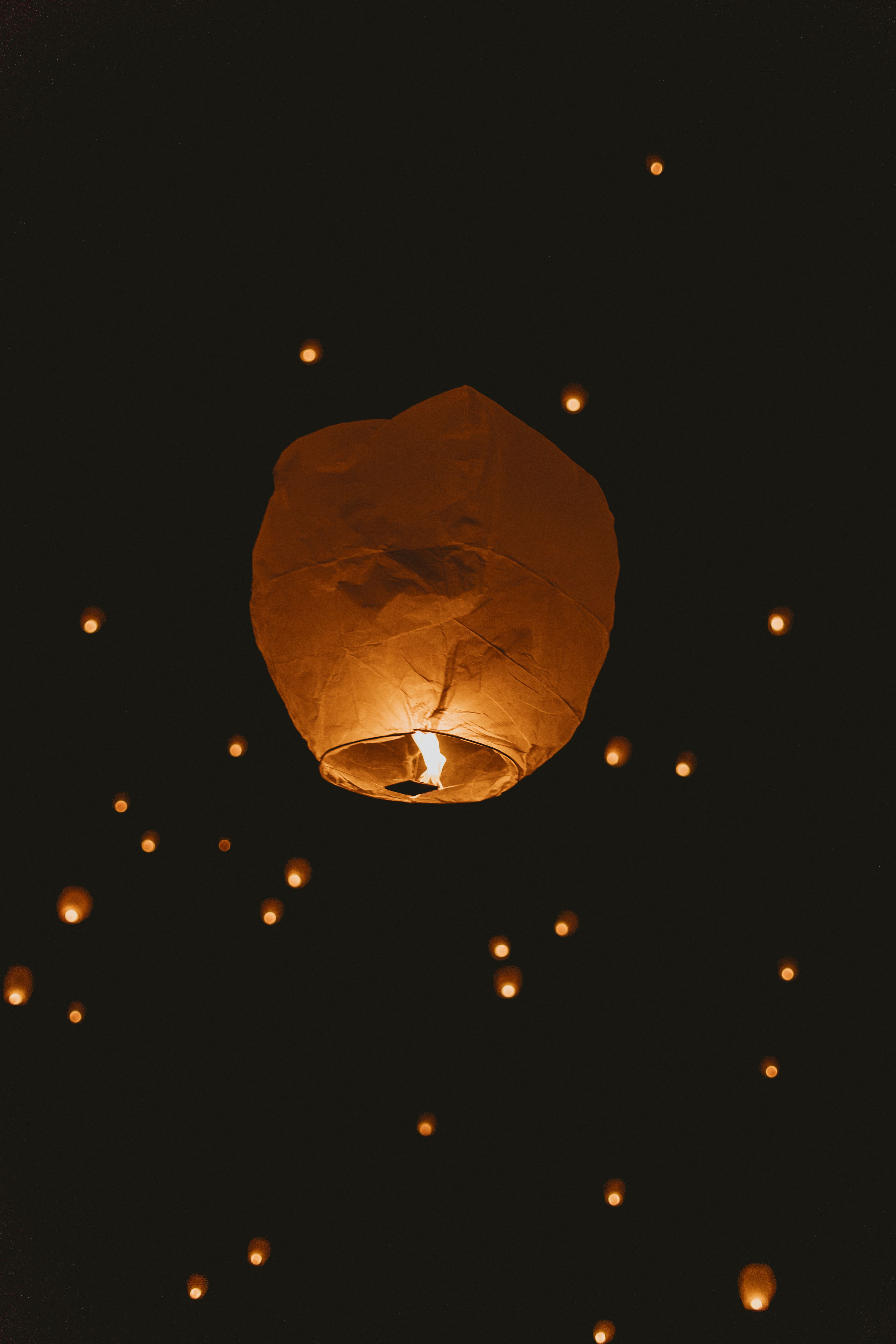A paper lantern rising into the night sky
