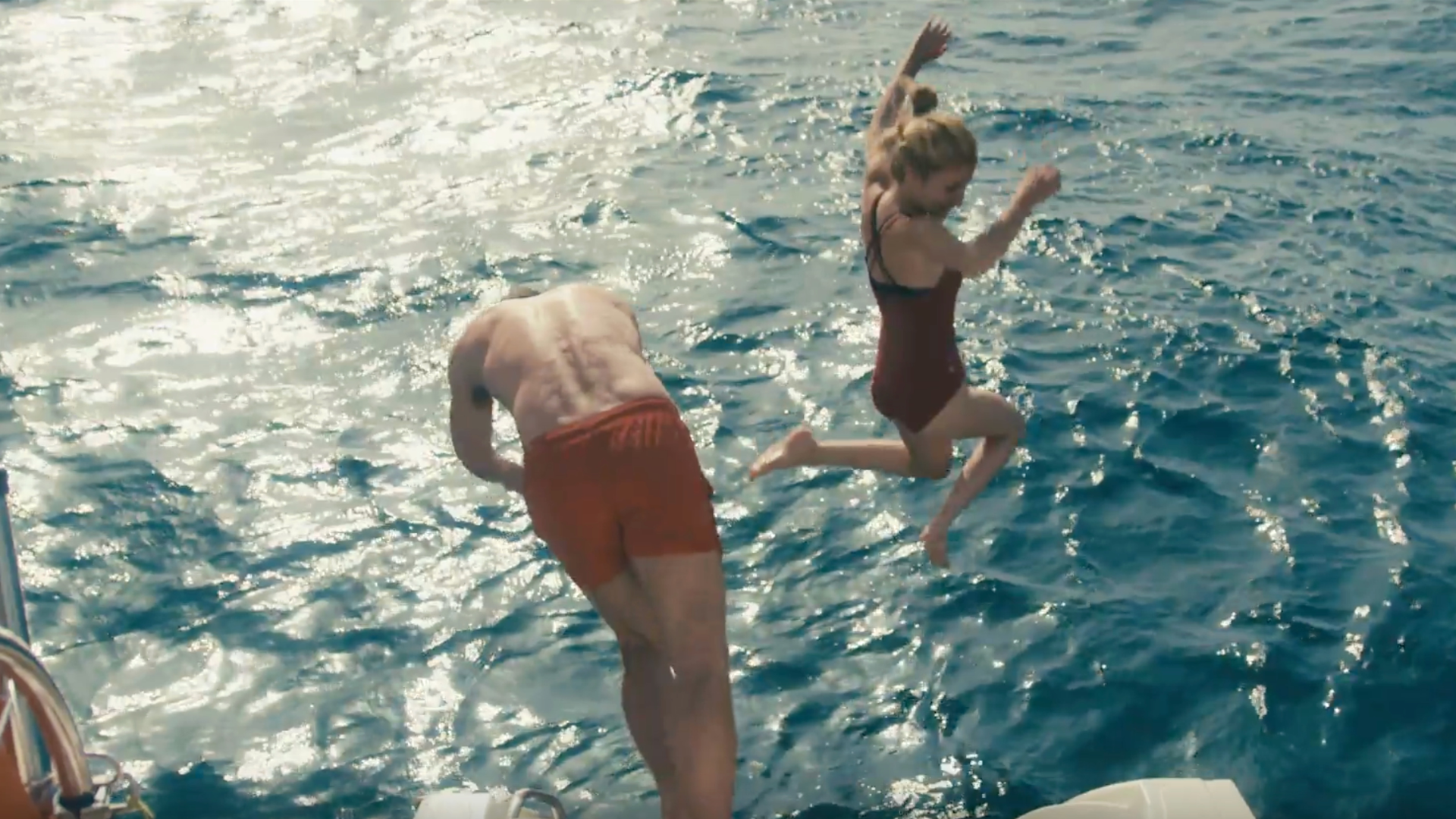 Two people leaping into the sea
